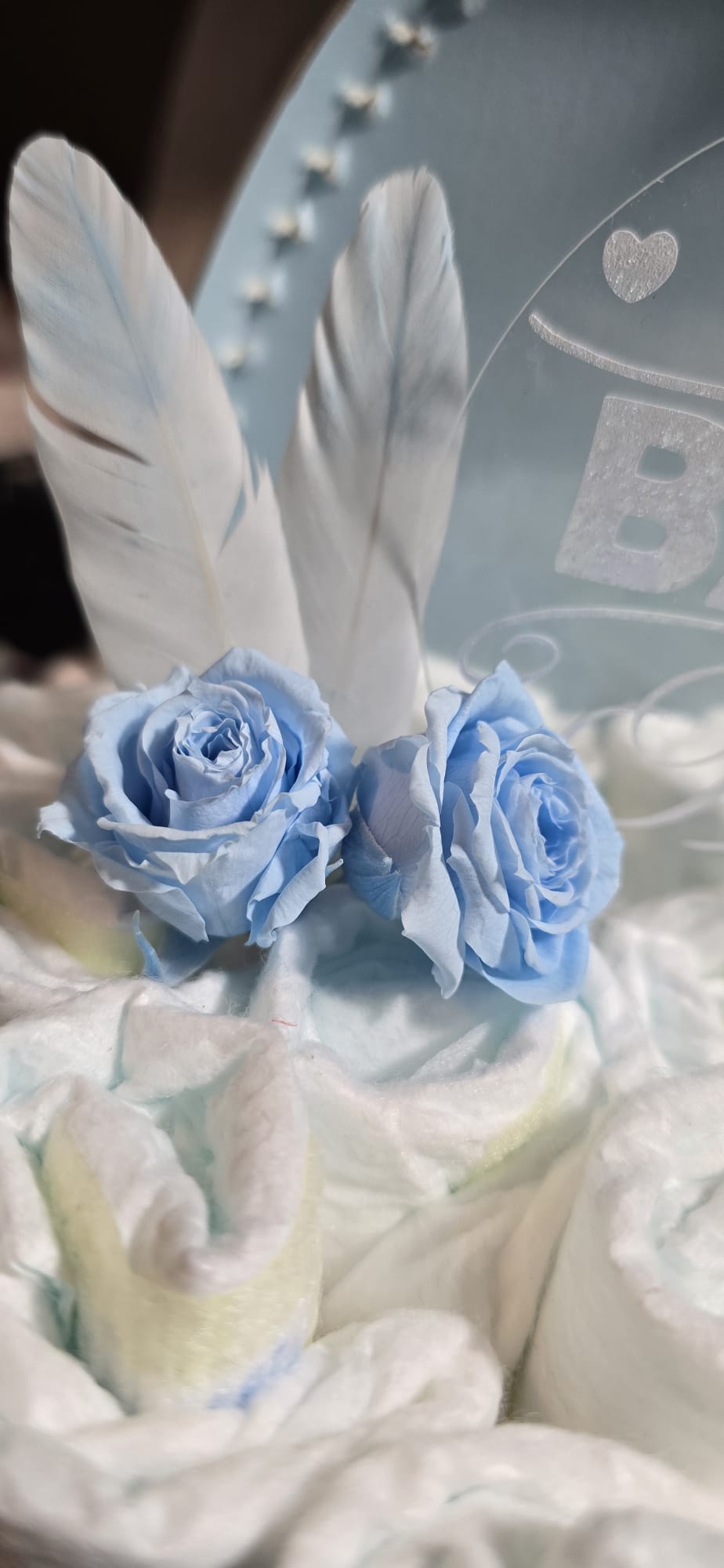 Luiertaart in een gepersonaliseerd blauw koffertje met knuffeltje giraf gus en echte longlife rozen