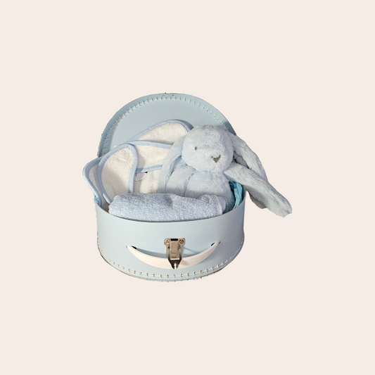 Maternity gift blue suitcase with cuddly bunny, bib, and burp cloth